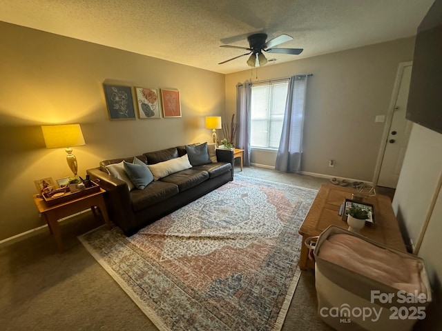 living area with a ceiling fan, dark carpet, a textured ceiling, and baseboards