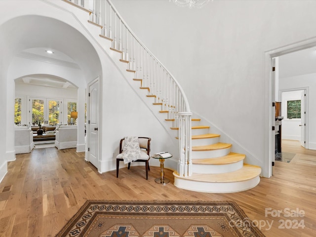 stairs featuring hardwood / wood-style flooring and french doors