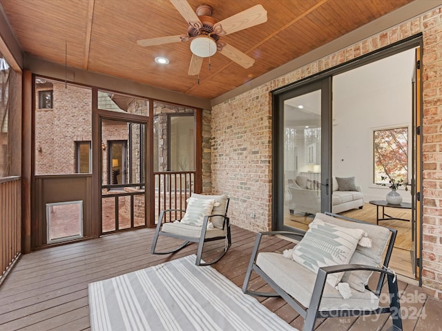 sunroom with ceiling fan and wood ceiling