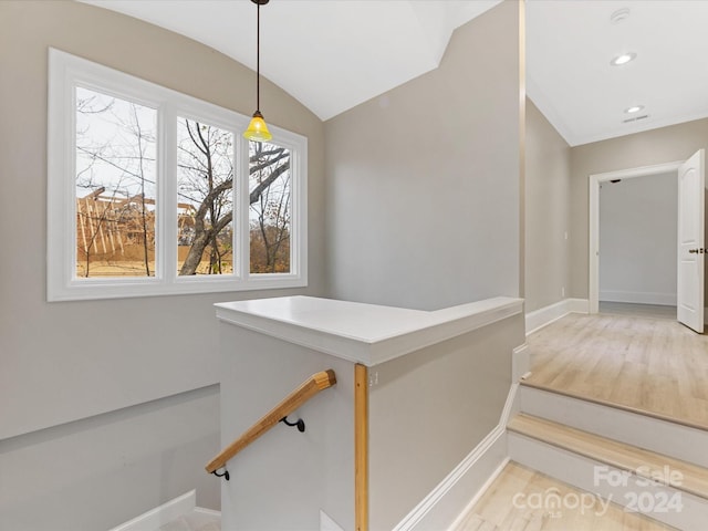 staircase with lofted ceiling and hardwood / wood-style flooring