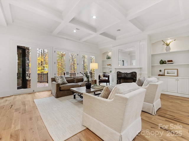 living room featuring beamed ceiling, coffered ceiling, built in features, and light wood-type flooring