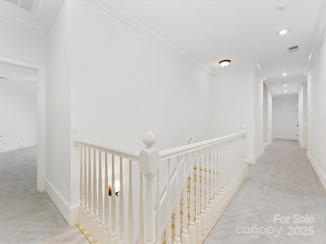 corridor featuring crown molding and light colored carpet