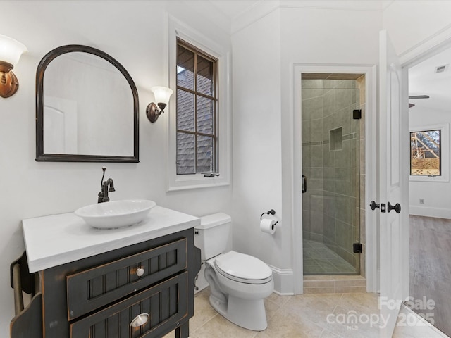 bathroom featuring walk in shower, tile patterned floors, vanity, and toilet