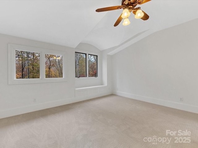 carpeted spare room with lofted ceiling