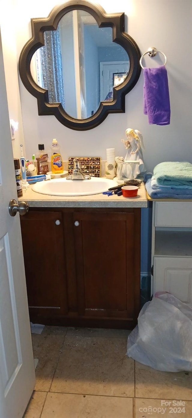 bathroom with tile patterned flooring and vanity