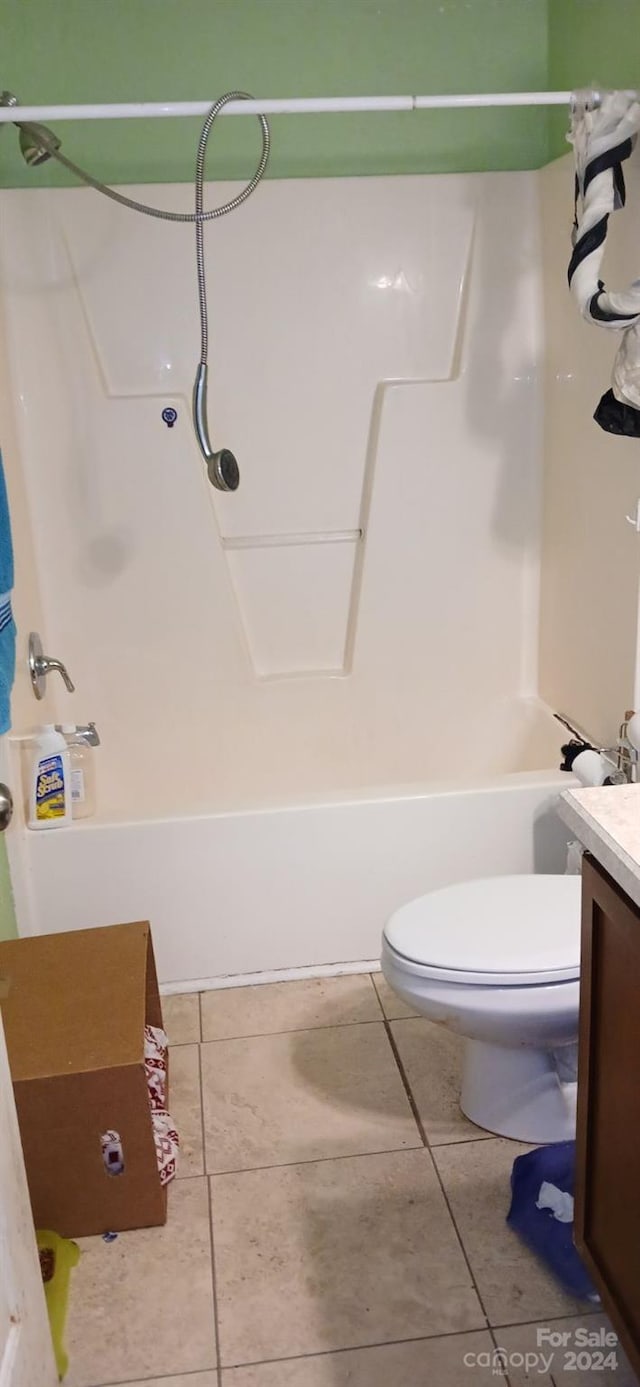 full bathroom with tile patterned floors, vanity, tub / shower combination, and toilet