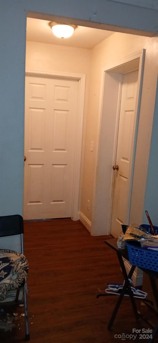 hallway with dark wood-type flooring