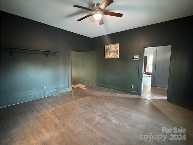 empty room with ceiling fan and hardwood / wood-style flooring