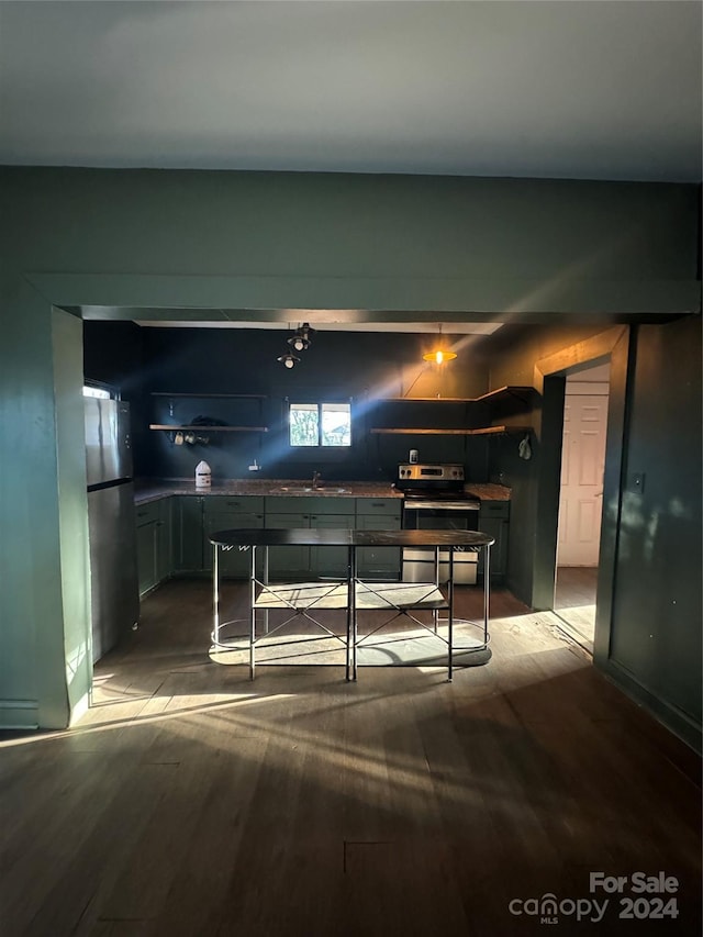 kitchen featuring hardwood / wood-style flooring, sink, and appliances with stainless steel finishes