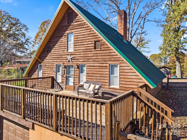 rear view of property featuring a deck