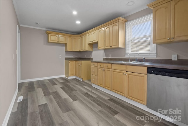 kitchen featuring a sink, dark wood-style floors, dishwasher, light brown cabinetry, and dark countertops