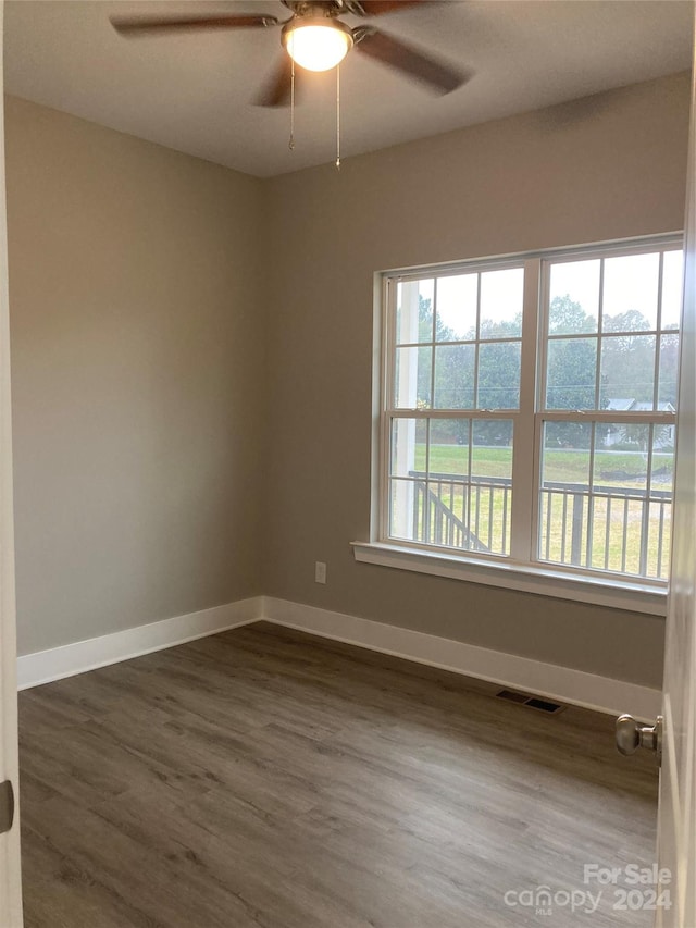 spare room with ceiling fan and dark hardwood / wood-style floors