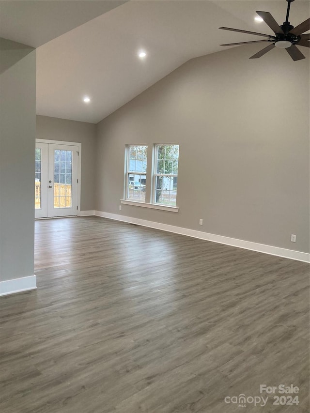 unfurnished living room with vaulted ceiling, ceiling fan, french doors, and dark hardwood / wood-style floors