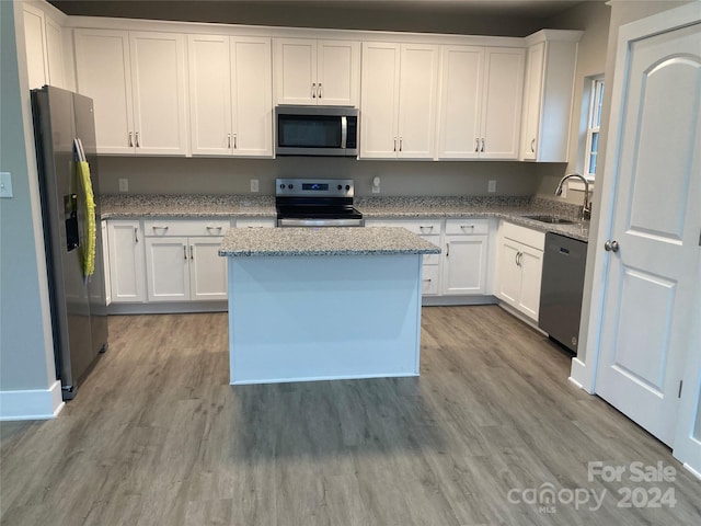 kitchen with white cabinetry, light hardwood / wood-style flooring, and appliances with stainless steel finishes