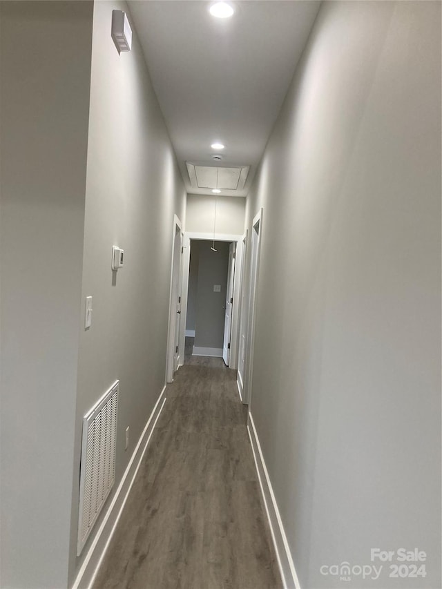 corridor with dark hardwood / wood-style flooring