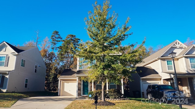 view of front of house with a front yard and a garage