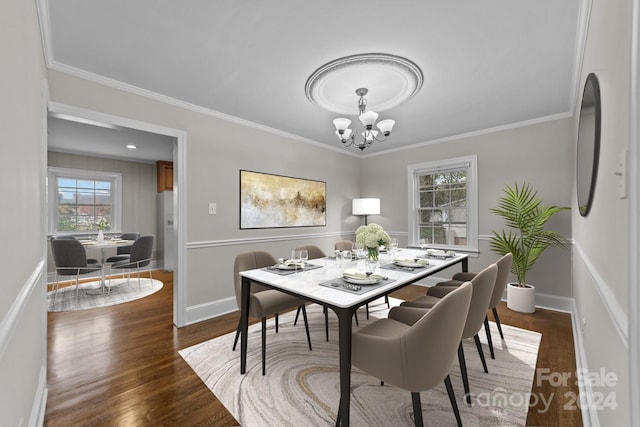 dining area featuring crown molding, dark hardwood / wood-style flooring, and a notable chandelier