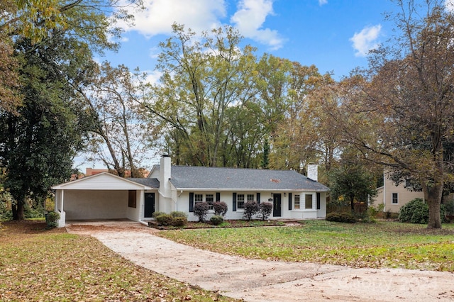 ranch-style house featuring a front lawn and a carport