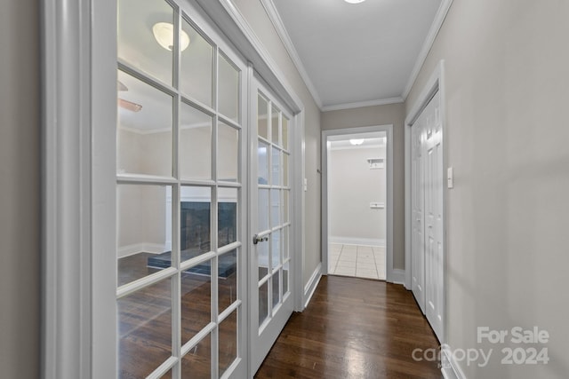 corridor featuring dark hardwood / wood-style floors, crown molding, and french doors