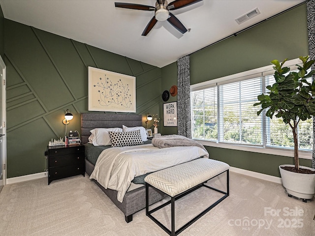 bedroom with light colored carpet and ceiling fan