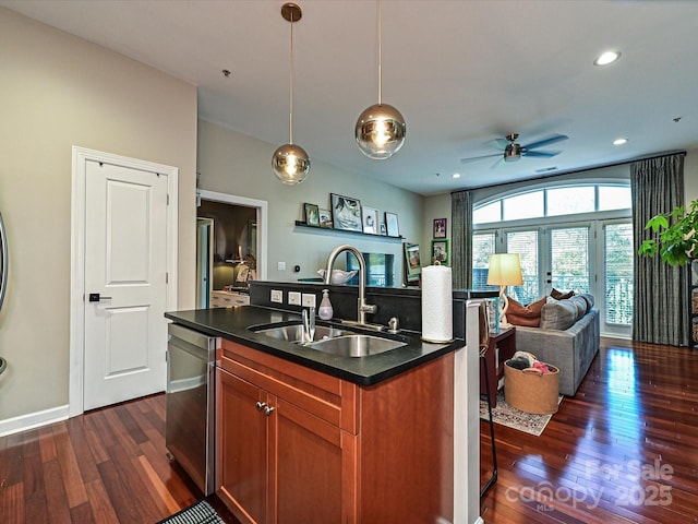 kitchen featuring decorative light fixtures, sink, dark wood-type flooring, and dishwasher