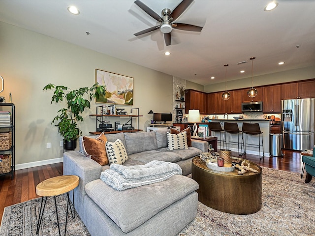 living room with dark hardwood / wood-style floors and ceiling fan