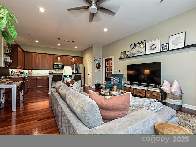 living room with dark hardwood / wood-style floors and ceiling fan