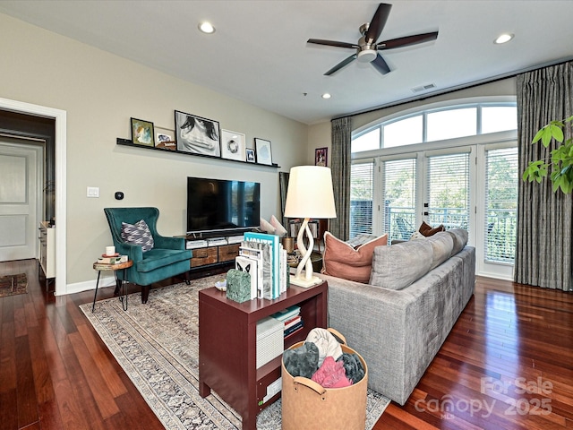 living room featuring ceiling fan, dark wood-type flooring, and french doors