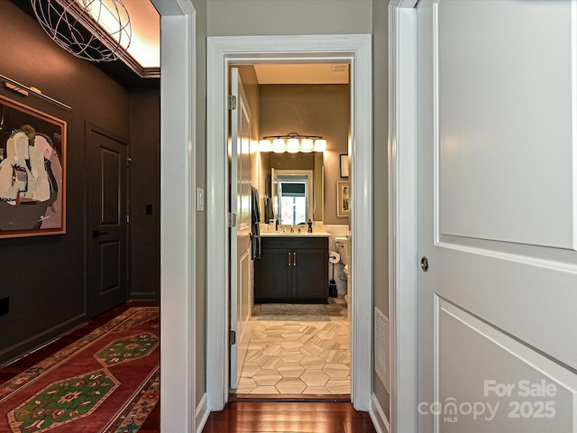 corridor with dark hardwood / wood-style flooring