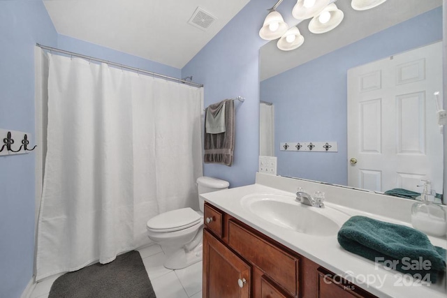 bathroom featuring toilet, vanity, tile patterned floors, and curtained shower