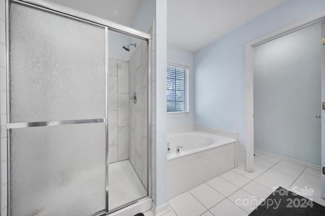 bathroom featuring tile patterned floors and independent shower and bath