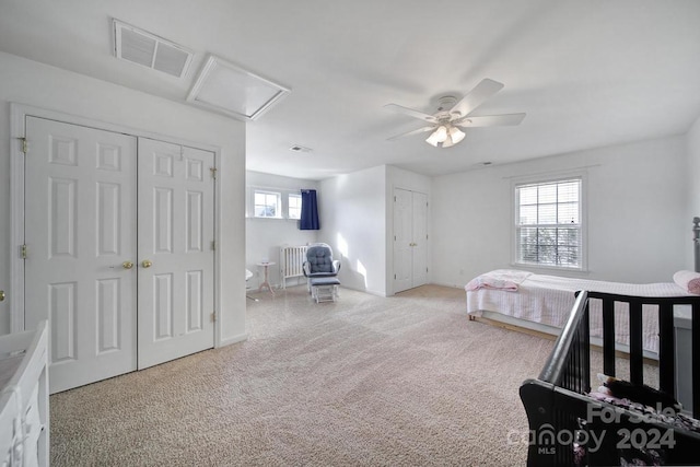 bedroom with ceiling fan and light carpet