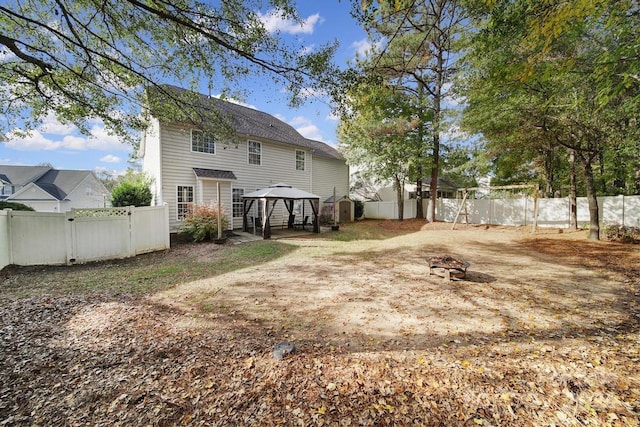 back of house featuring a gazebo