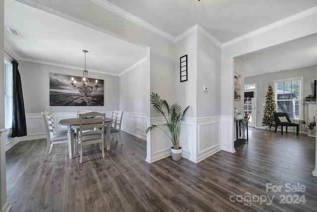 dining room featuring a notable chandelier, ornamental molding, and dark wood-type flooring