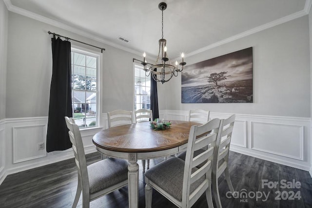 dining space with ornamental molding, a healthy amount of sunlight, dark hardwood / wood-style floors, and an inviting chandelier