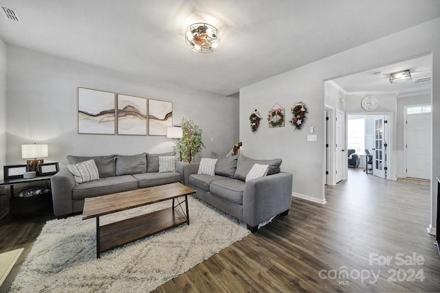 living room with crown molding, french doors, and dark hardwood / wood-style floors