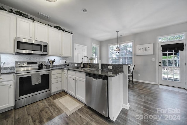 kitchen featuring white cabinetry, sink, a healthy amount of sunlight, and appliances with stainless steel finishes