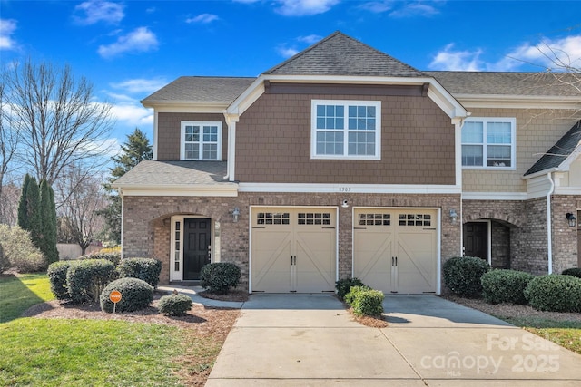 view of front of house with a garage, concrete driveway, brick siding, and a shingled roof