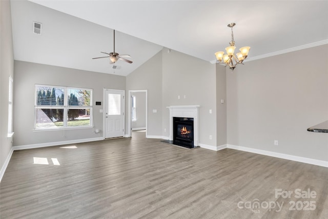 unfurnished living room with baseboards, visible vents, wood finished floors, and a glass covered fireplace