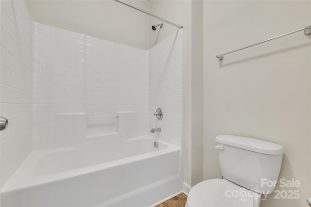 bathroom featuring bathtub / shower combination and toilet