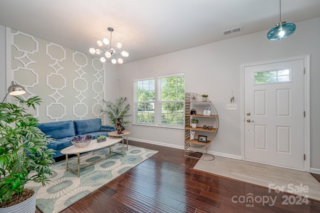 entryway featuring hardwood / wood-style flooring and an inviting chandelier