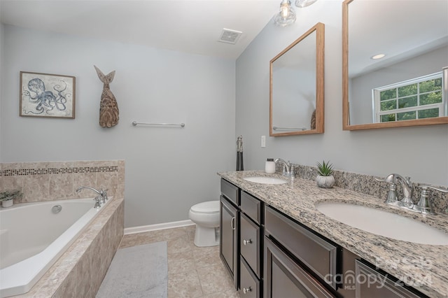 bathroom with toilet, vanity, a relaxing tiled tub, and tile patterned flooring