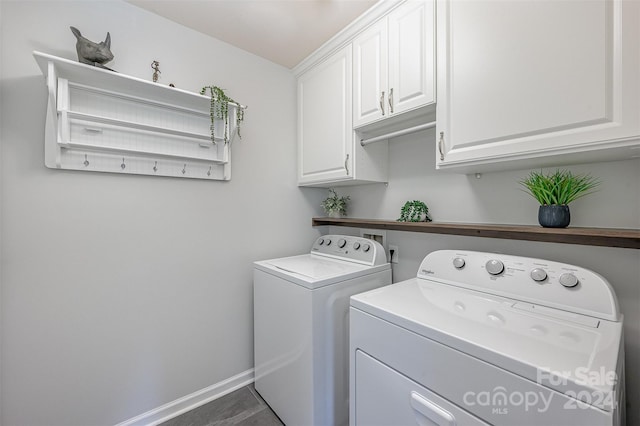 washroom featuring dark tile patterned flooring, cabinets, and washing machine and clothes dryer