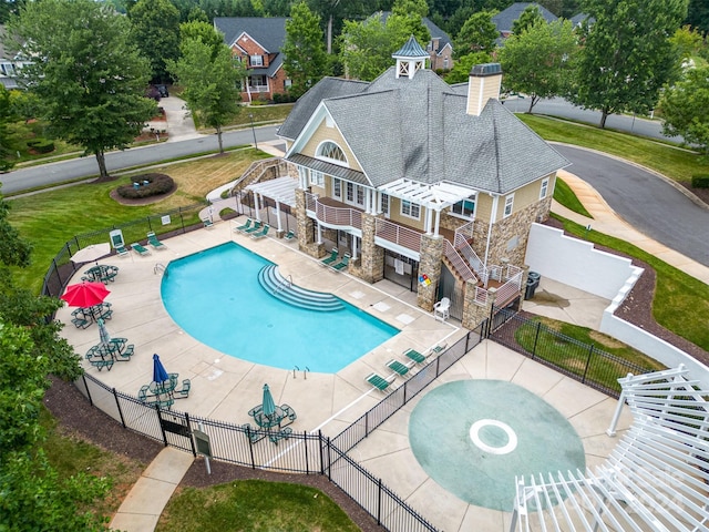 view of swimming pool featuring a lawn and a patio area