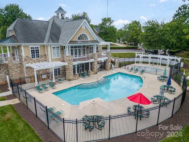 view of swimming pool with a patio area and a pergola