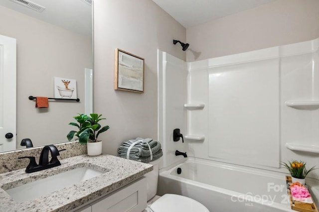 bathroom with visible vents, toilet, bathtub / shower combination, and vanity