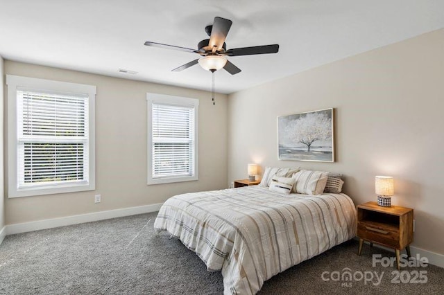 bedroom featuring multiple windows, baseboards, and carpet floors