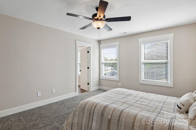 carpeted bedroom with baseboards and ceiling fan