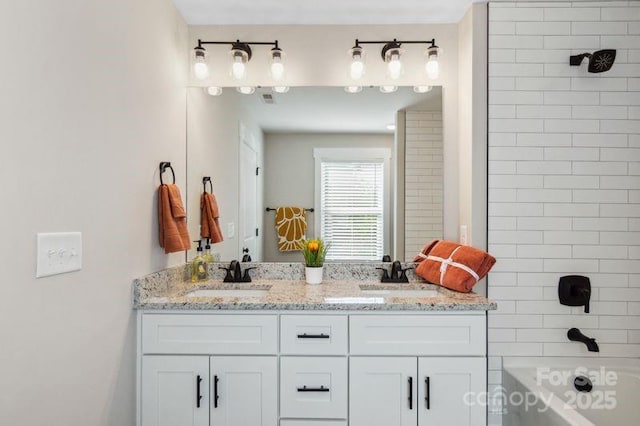 bathroom with a sink, bathtub / shower combination, and double vanity