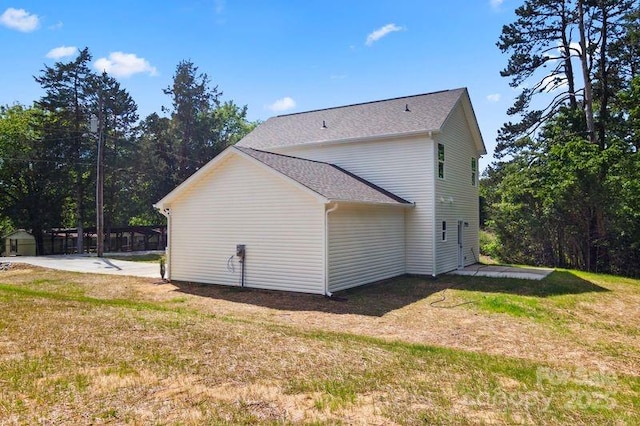 view of property exterior with a yard